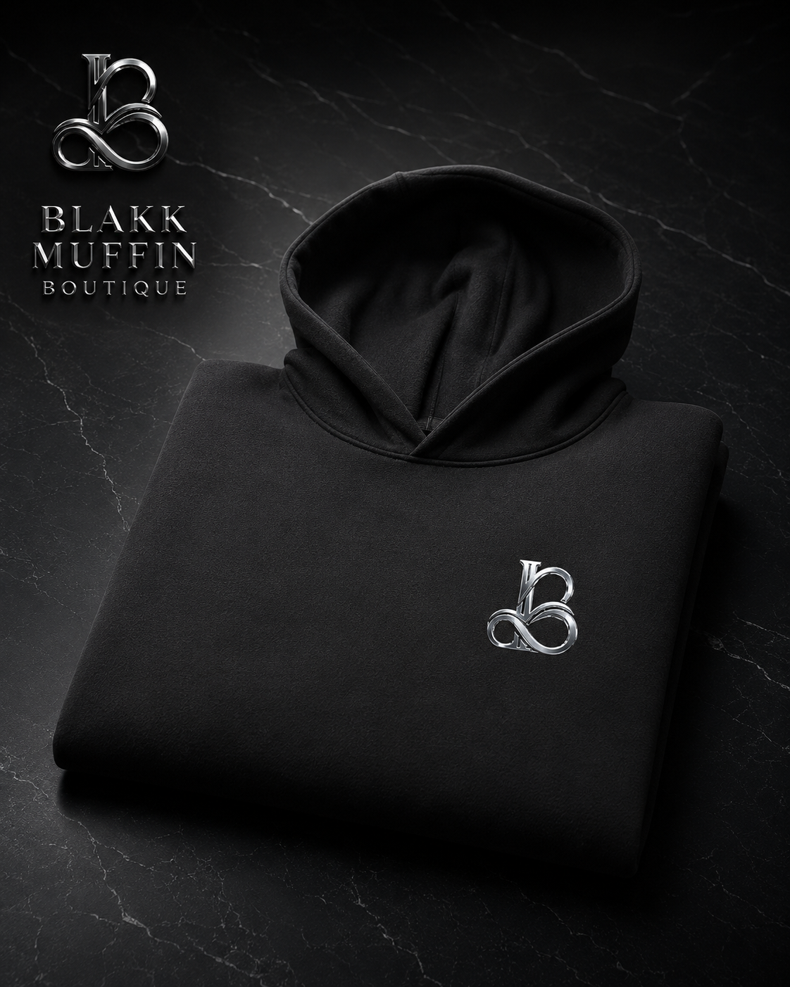 Black hoodie with a logo on a dark background, featuring Blakk Muffin Boutique branding.
